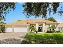 Charming one-story home featuring a well-manicured lawn, beautiful landscaping, and a double-door entrance at 6426 Montclair Bluff Ln, Windermere, FL 34786