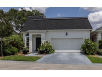 Charming single-story home with a two-car garage and well-maintained landscaping at 907 Sussex Close # 4, Orlando, FL 32804