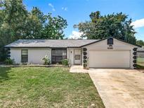 Charming single-story home with a well-maintained lawn and attached one car garage at 1089 Algoma St, Deltona, FL 32725