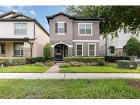 Charming two-story home with a landscaped front yard, inviting entrance, and neutral-colored exterior at 14215 Lakeview Park Rd, Winter Garden, FL 34787