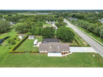Sprawling property with a pool, RV, additional storage, and a large, meticulously maintained lawn at 15650 Catherine Cir, Groveland, FL 34736