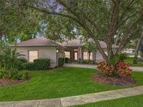 Charming single-story home featuring lush landscaping, a well-manicured lawn, and a welcoming facade at 1701 Lucky Pennie Way, Apopka, FL 32712