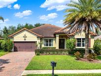 Charming single-story home boasts a well-manicured lawn, a tiled roof, and mature landscaping at 172 Verde Way, Debary, FL 32713
