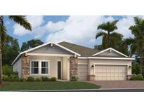 Beautiful single-Gathering home featuring stone accents, a two-car garage, and a well-manicured lawn at 2227 Rider Rain Ln, Apopka, FL 32703