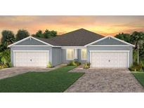 Charming single-Gathering home with lush green lawn, brick paved driveway, and an attached two-car garage at 2334 Daisy Tree Rd, St Cloud, FL 34771