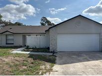 Charming single-story home with an attached two-car garage and well-maintained landscaping at 3187 Shady Willow Dr, Orlando, FL 32808