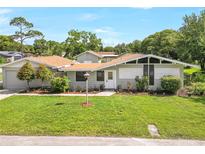 Charming single-story home featuring a well-manicured lawn and mature landscaping at 338 Eastern Ave, St Cloud, FL 34769