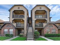 Condo exterior with two-story facade, balconies, and central staircase at 351 Lone Hill Dr # 206, Altamonte Springs, FL 32701