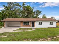 Charming single-story home featuring brick accents, an open carport, and a well-maintained lawn at 4116 Sw 20Th St, Ocala, FL 34474