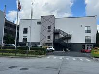 Exterior shot of building featuring modern architecture, parking area, and stairwell on a partly cloudy day at 62 W Colonial Dr # 302, Orlando, FL 32801