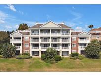 Beautiful condominium with multiple levels, balconies, and well-manicured landscaping at 7616 Cabana Ct # 301, Reunion, FL 34747