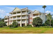 Stunning condo building featuring multiple balconies and lush landscaping, perfect for enjoying the outdoors at 7616 Cabana Ct # 301, Reunion, FL 34747