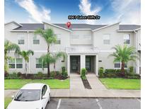 Contemporary townhome featuring clean lines, well-maintained landscaping, and a convenient parking space at 8961 Cabot Cliffs Dr, Davenport, FL 33896