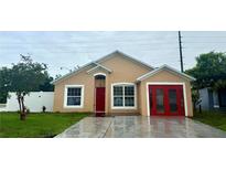 Charming single-story home with a well-maintained lawn and bright red front door at 1001 Golfside Ct, Kissimmee, FL 34741