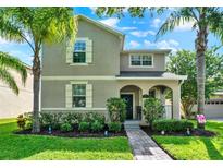 Charming two-story home featuring landscaped front yard and inviting covered porch at 15613 Camp Dubois Cres, Winter Garden, FL 34787