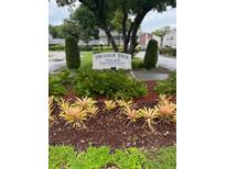 Well-manicured flower garden surrounding the Orange Tree Village Condominiums sign at 2776 Curry Ford Rd # Ge, Orlando, FL 32806