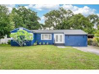 Charming blue single-story home with a well-maintained lawn and fresh landscaping at 3007 Knollwood Cir, Orlando, FL 32804