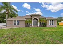 Charming single-story home with well-manicured lawn and elegant architectural details at 3779 N Econlockhatchee Trl, Orlando, FL 32817