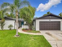 Charming single-Gathering home featuring a well-maintained lawn, brick accents and attached two car garage at 8676 Hillside Dr, Orlando, FL 32810