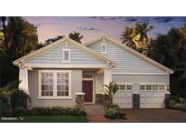 Charming home features light blue shingles, stone accents, two-car garage, and well-maintained landscaping at 11045 Hollow Bay Dr, Winter Garden, FL 34787