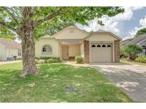 Charming single-story home with a well-manicured lawn and a cozy, welcoming facade at 123 Edgewater Cir, Sanford, FL 32773
