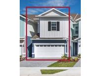 Charming two-story townhome with attached garage, well-kept lawn, and traditional architectural details at 1267 Stockwell Ave, St Cloud, FL 34771