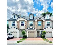 Charming townhomes with brick driveways, dormer windows, and stone facade accents creating curb appeal at 3118 Crown Jewel Ct, Winter Park, FL 32792