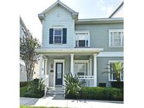 Charming two-story townhouse with a welcoming front porch and well-maintained landscaping at 335 Lansbrook Ln, Winter Springs, FL 32708