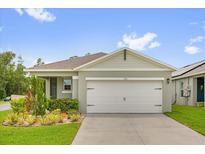 Charming single-story home with a two-car garage and beautifully landscaped front yard at 336 Pelham Park Dr, Deland, FL 32720
