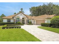 Charming single-story home with well-manicured lawn, paver driveway, and lush landscaping at 3430 Regal Crest Dr, Longwood, FL 32779