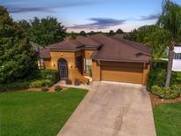 Charming single-story home features a well-manicured lawn, mature landscaping, and a welcoming entrance at 3562 Foxchase Dr, Clermont, FL 34711