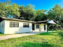 Charming single-story home with a covered parking area and freshly painted brick exterior at 425 Walnut St, Daytona Beach, FL 32114