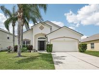 Charming single-Gathering home with mature palm trees and a well-manicured lawn at 504 Key Haven Dr, Sanford, FL 32771