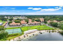 Expansive aerial view of the community, showcasing lush landscaping, water access, and recreational amenities at 5323 Hansel Ave # E14, Orlando, FL 32809