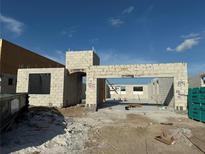 Construction site showing the concrete block walls and foundation of a new residential building under a blue sky at 813 River Stone Trl, Sanford, FL 32771