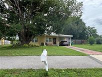 Charming single-story home with a covered carport and mature tree in the front yard at 108 Country Club Cir, Sanford, FL 32771