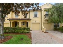 Charming townhome with a paver driveway, well-kept landscaping, and attached garage at 1277 Blessing St, Maitland, FL 32751