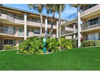 Exterior of a condo building with lush tropical landscaping and palm trees at 145 Oyster Bay Cir # 140, Altamonte Springs, FL 32701