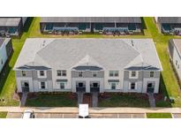 Aerial view of new two story townhomes showcasing modern architectural details and professional landscaping at 16061 Blue Wave Way, Clermont, FL 34714