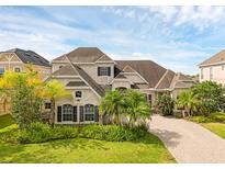 Charming two-story home with lush landscaping and a brick driveway at 16120 Bristol Lake Cir, Orlando, FL 32828