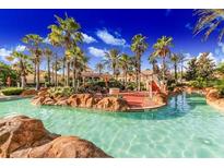 Large community pool featuring tropical landscaping and palm trees at 223 Palermo St, Davenport, FL 33897
