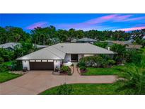 Stunning single-story home boasting a well-manicured lawn and a modern metal roof for lasting curb appeal at 225 Temple Cir, Eustis, FL 32726
