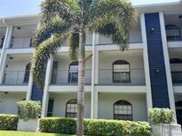 Three-story condo with balconies, windows, and a nicely landscaped lawn at 25210 Northlake Dr # 210, Sanford, FL 32773