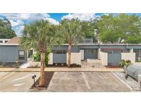 Charming single-story home with modern blue exterior, well-kept front yard, and mature palm trees at 2541 Leeward Way, Winter Park, FL 32792
