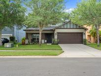 Charming single-story home with a well-manicured lawn and a two-car attached garage at 2604 Bullion Loop, Sanford, FL 32771