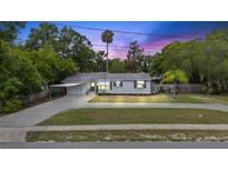 Charming single-story home with well-maintained lawn, carport, and inviting curb appeal, perfect for a cozy Gathering residence at 330 N Stone St, Deland, FL 32720