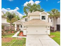 Charming two-story home featuring a two-car garage, lush landscaping, and inviting front entrance at 345 Goldstone Pl, Lake Mary, FL 32746