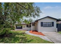 Charming single-story home with a well-maintained lawn and a inviting walkway at 418 Tulane Dr, Altamonte Springs, FL 32714