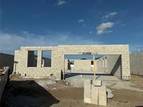 New home construction site showing concrete block walls and rough openings under a blue sky at 817 River Stone Trl, Sanford, FL 32771