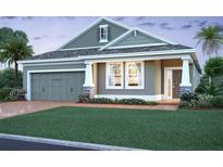 Charming single-Gathering home featuring a welcoming front porch, two-car garage, and well-maintained landscaping at 817 River Stone Trl, Sanford, FL 32771